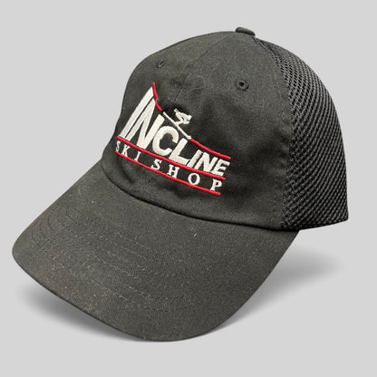 Raree Finds vintage black Incline Ski Shop trucker hat with white and red embroidered skier logo and mesh back.