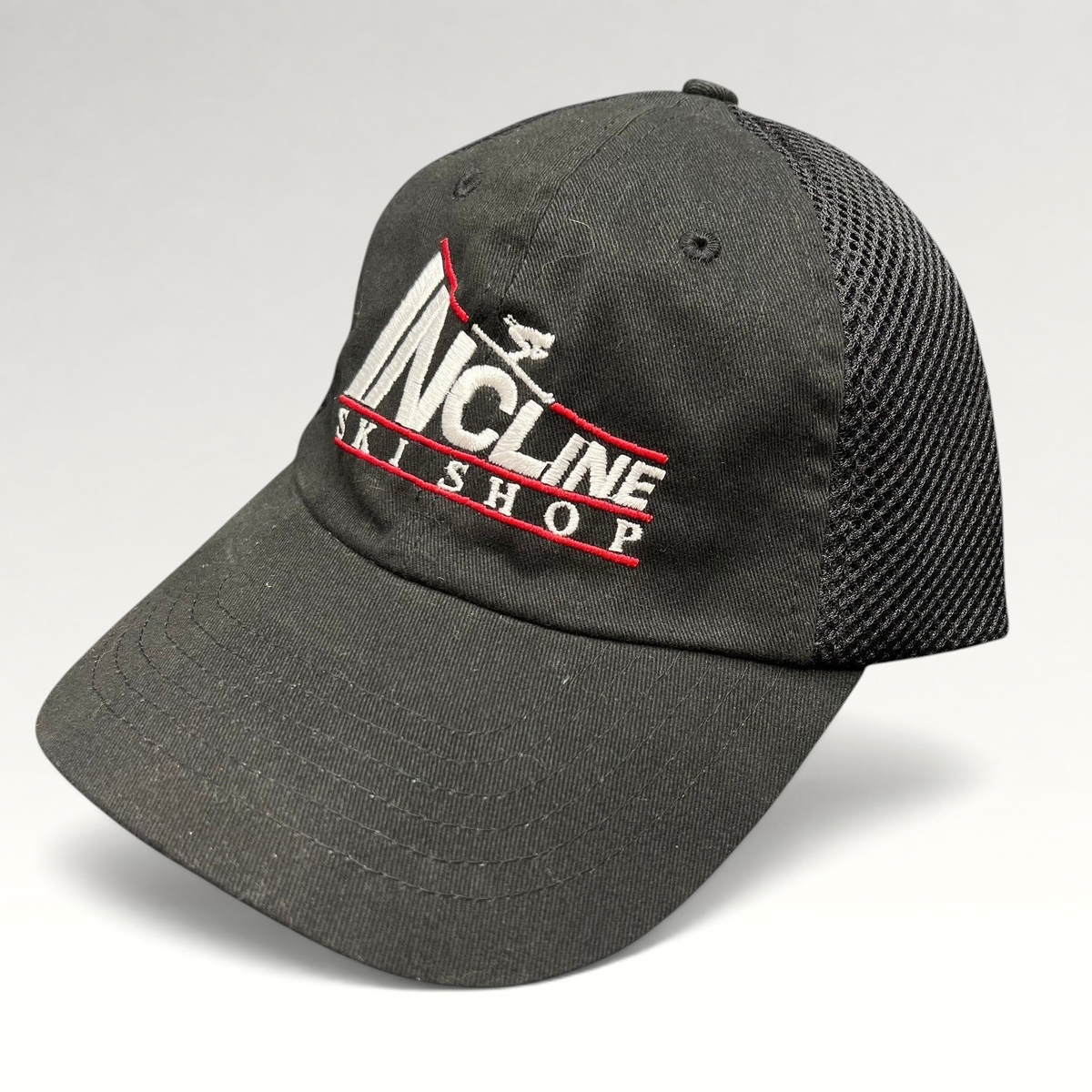 Raree Finds vintage black Incline Ski Shop trucker hat with white and red embroidered skier logo and mesh back.