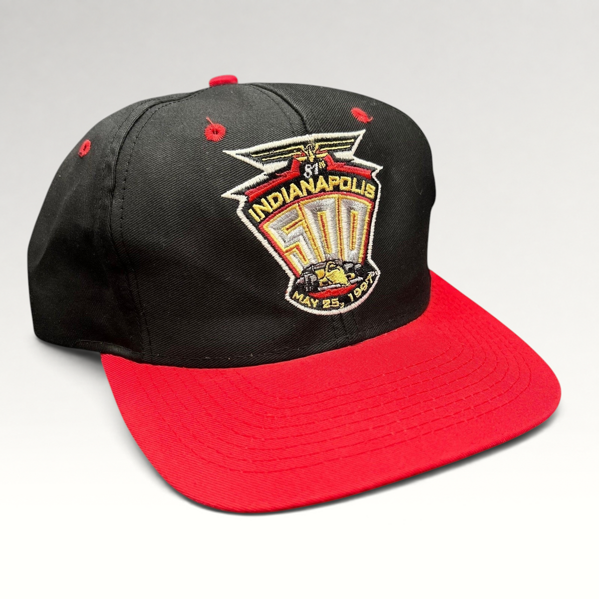 Raree Finds vintage 1997 Indianapolis 500 snapback hat with black crown, red brim, and embroidered race logo.