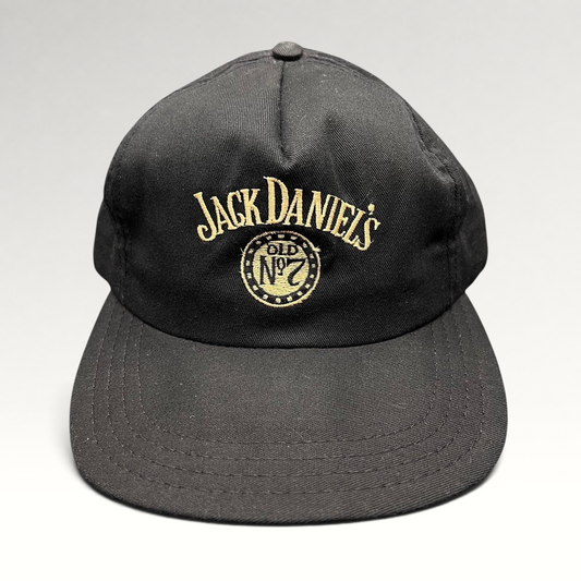 Raree Finds vintage 90s black Jack Daniel’s Old No. 7 snapback hat with gold embroidered logo and structured crown.