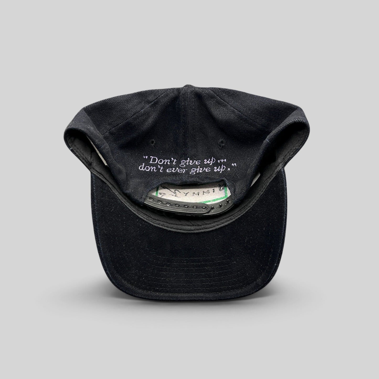 Raree Finds vintage black cotton snapback hat featuring the embroidered Jimmy V quote inside the crown
