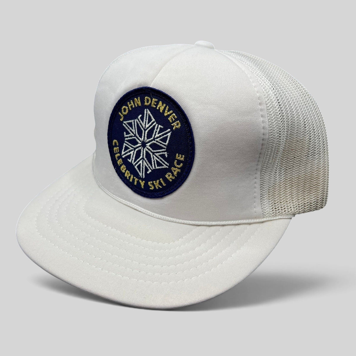 Raree Finds vintage 80s white foam trucker hat with John Denver Celebrity Ski Race snowflake patch and mesh back
