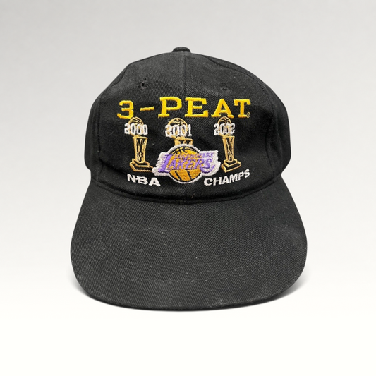 Raree Finds vintage black Los Angeles Lakers 3-Peat NBA champions cotton hat with gold, purple, and white embroidery.
