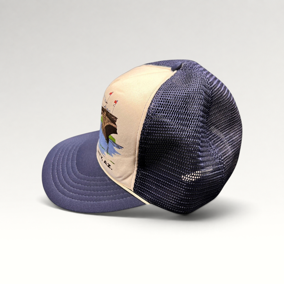 Raree Finds vintage 80s navy and white foam trucker hat featuring a London Bridge Lake Havasu City graphic print