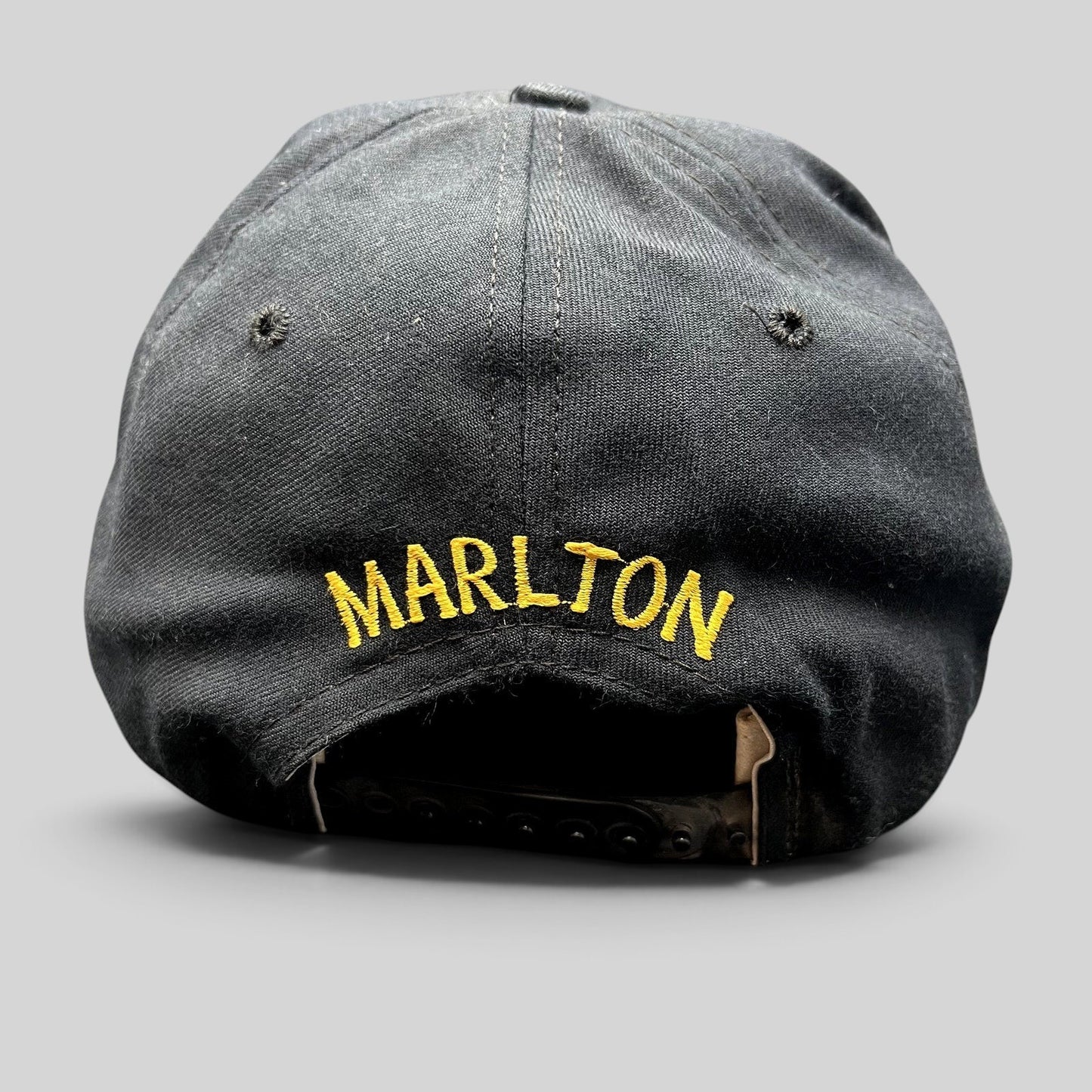 Raree Finds vintage black New Era snapback hat with gold Marlton embroidery on the back and adjustable plastic strap.