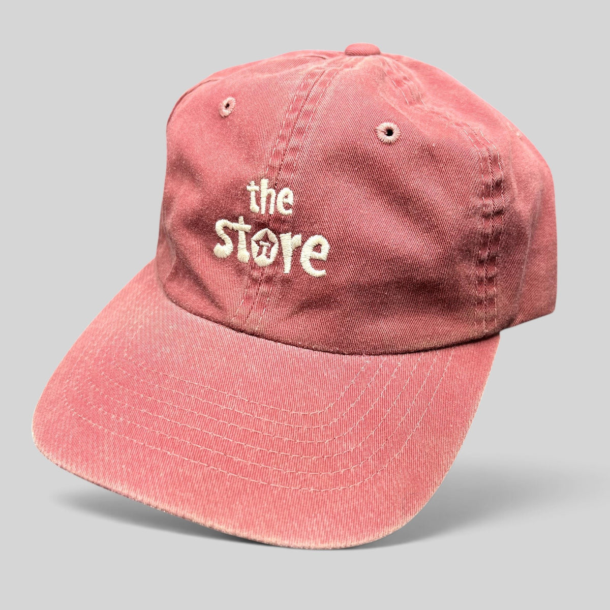 Raree Finds vintage maroon cotton Sportsman dad cap with embroidered The Store logo and adjustable strapback closure.