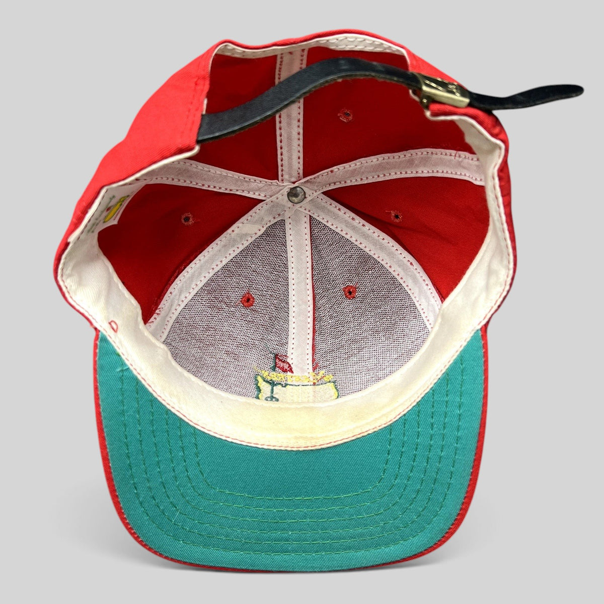 Raree Finds vintage American Needle Masters Augusta National strapback hat showing red crown and green underbrim