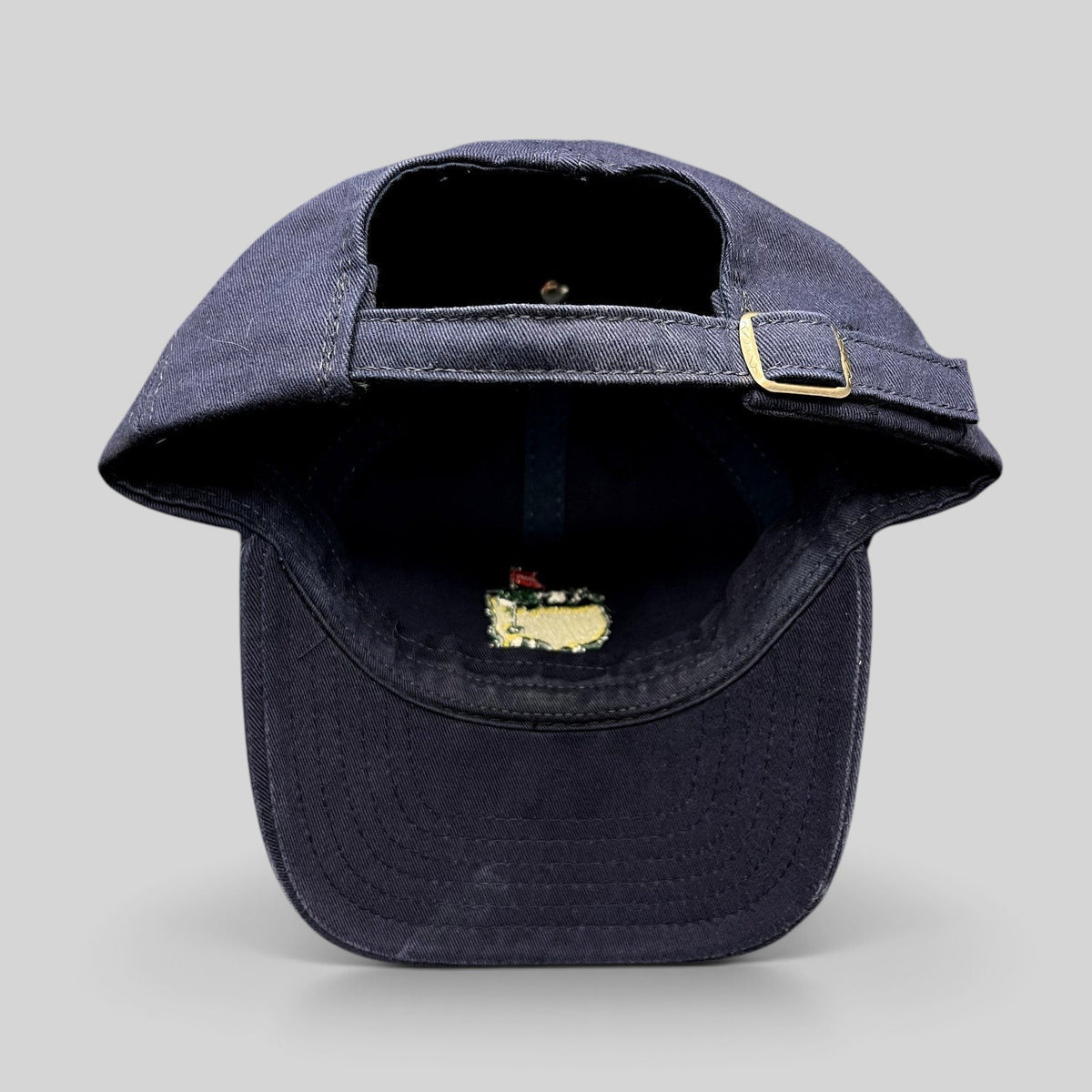 Raree Finds vintage navy blue Masters Tournament strapback hat with brass buckle and interior embroidered logo