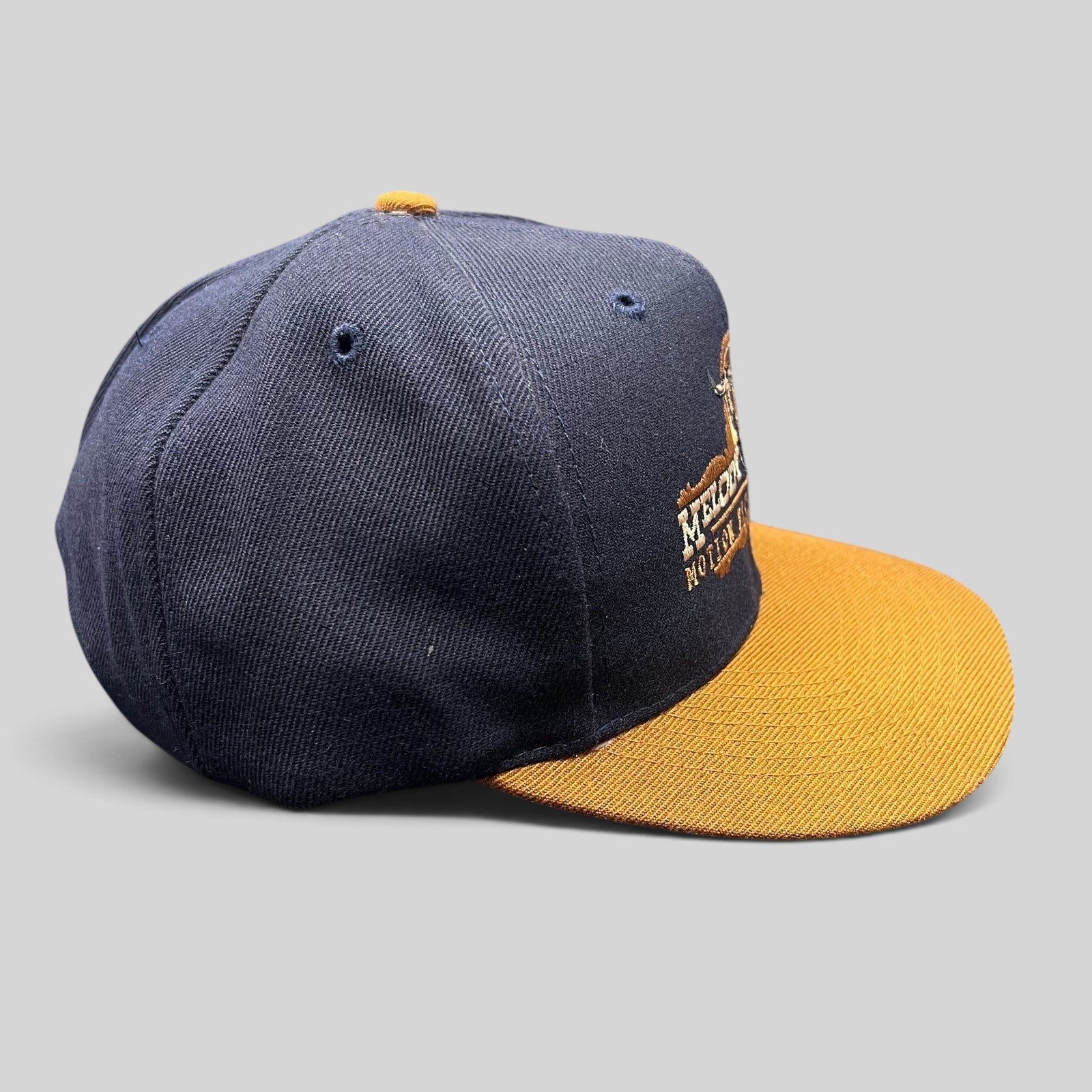 Raree Finds vintage navy and tan snapback hat featuring an embroidered Melody Ranch longhorn skull logo