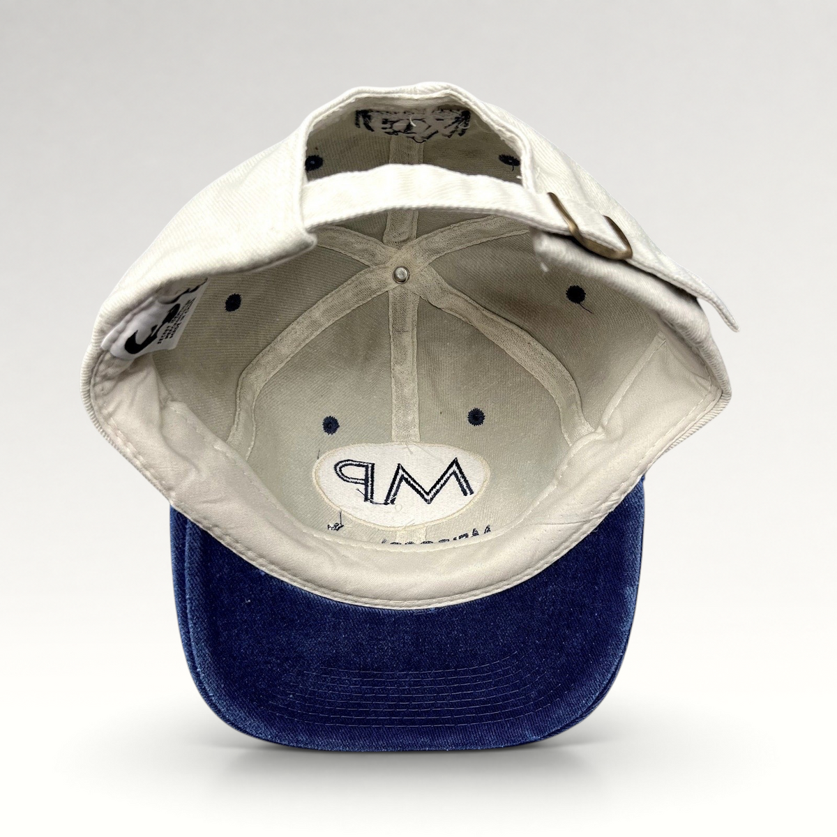 Raree Finds vintage Melrose Place FOX TV show strapback hat with cream crown, blue brim, and interior MP logo detail.