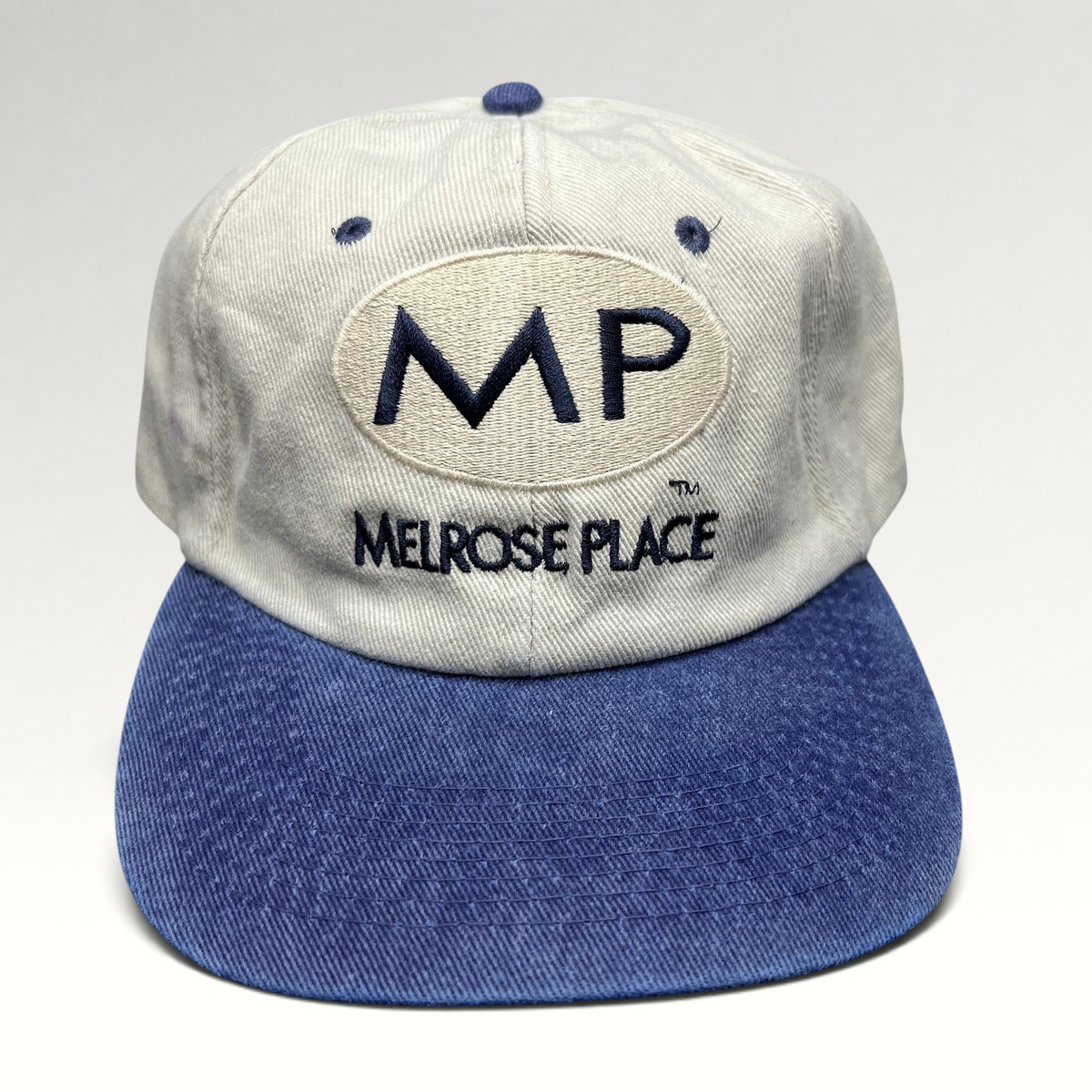 Raree Finds vintage Melrose Place FOX TV show strapback hat with cream crown, blue brim, and navy embroidered logo.