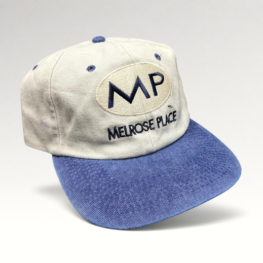 Raree Finds vintage 90s Melrose Place FOX TV show strapback hat with cream crown, blue brim, and embroidered MP logo.