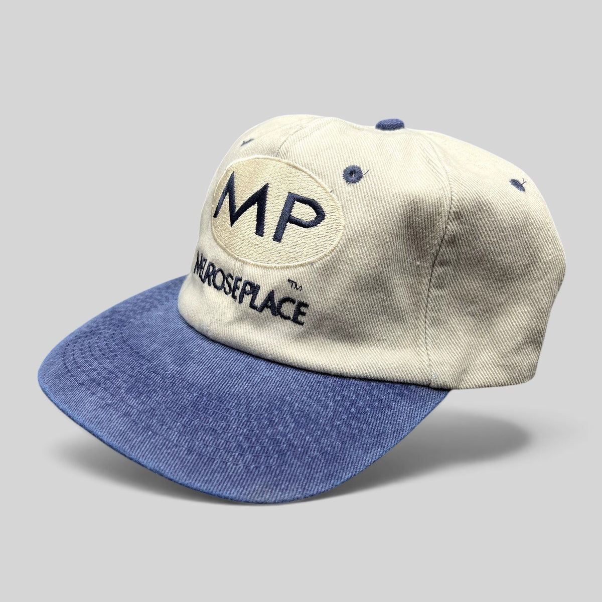 Raree Finds vintage 90s Melrose Place FOX TV show strapback hat with cream crown, blue brim, and navy embroidery.