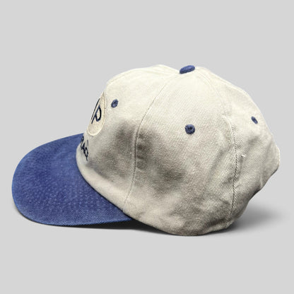 Raree Finds vintage 90s Melrose Place FOX TV show strapback hat with cream crown, blue brim, and embroidered logo.