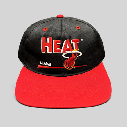 Raree Finds vintage 1990s Miami Heat snapback hat with black crown, red brim, and embroidered flaming basketball logo.