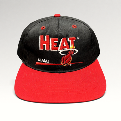 Raree Finds vintage 1990s Miami Heat snapback hat with black crown, red brim, and embroidered flaming basketball logo.