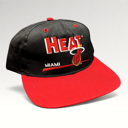 Raree Finds vintage 1990s Miami Heat snapback hat with black crown, red brim, and embroidered flaming basketball logo.