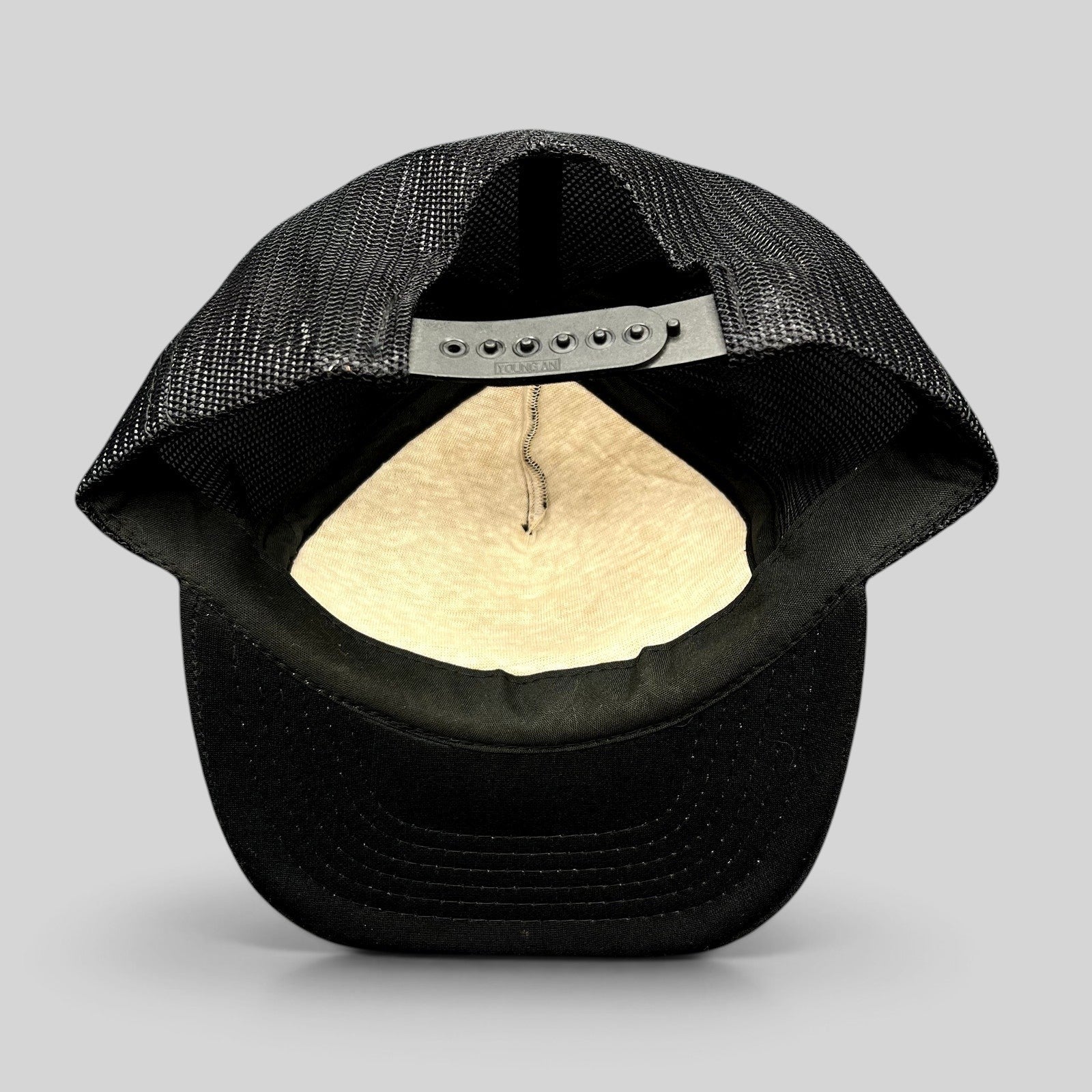 Raree Finds vintage Miami Vice black mesh trucker hat showing the interior foam lining and adjustable snapback closure