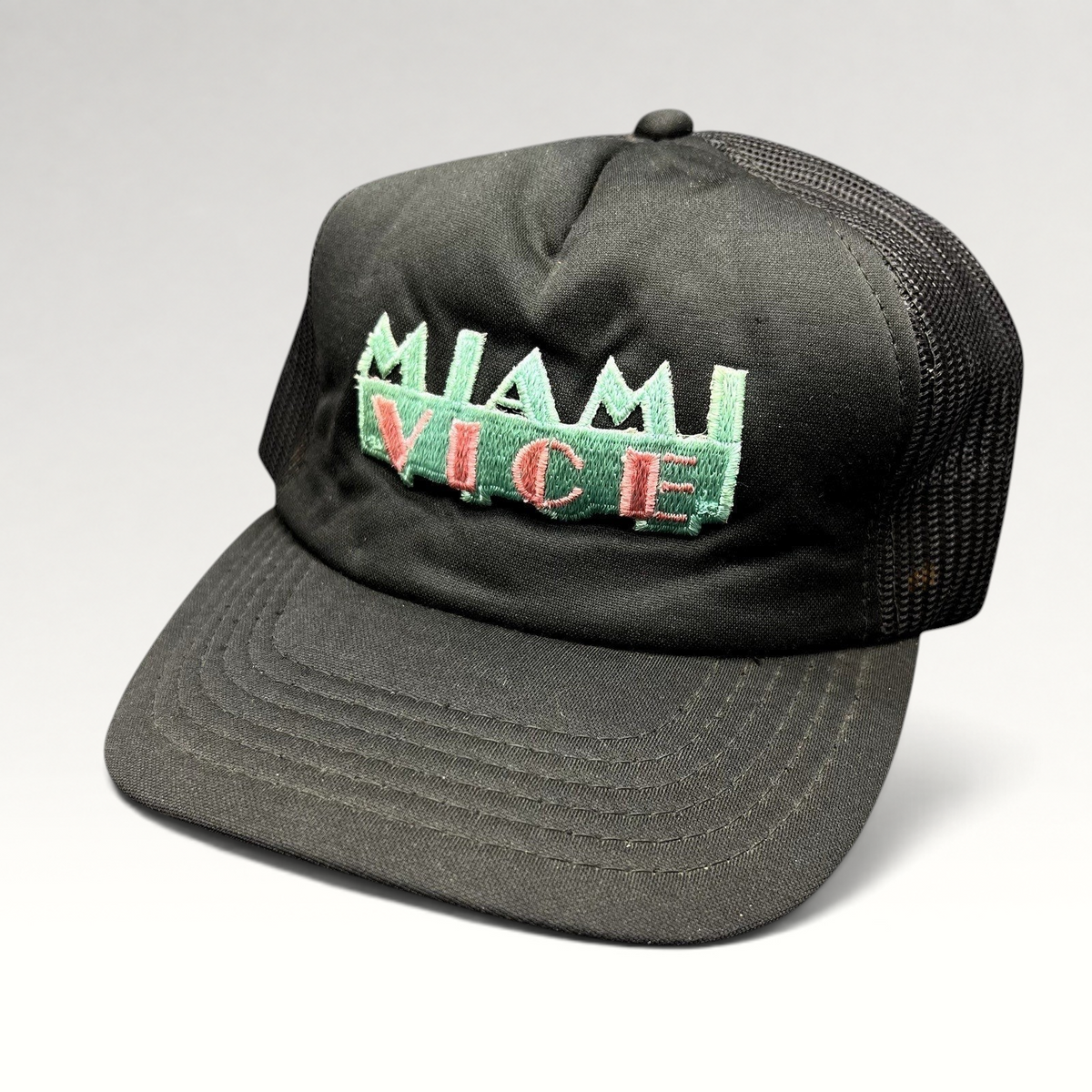 Raree Finds vintage Miami Vice black foam and mesh trucker hat with teal and pink embroidered logo and snapback.