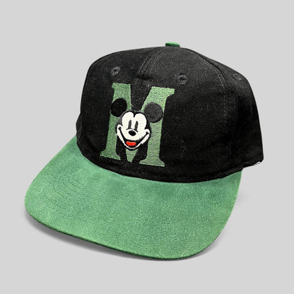 Raree Finds vintage 90s Disney Store Mickey Mouse snapback hat with black crown, green brim, and embroidered M logo.