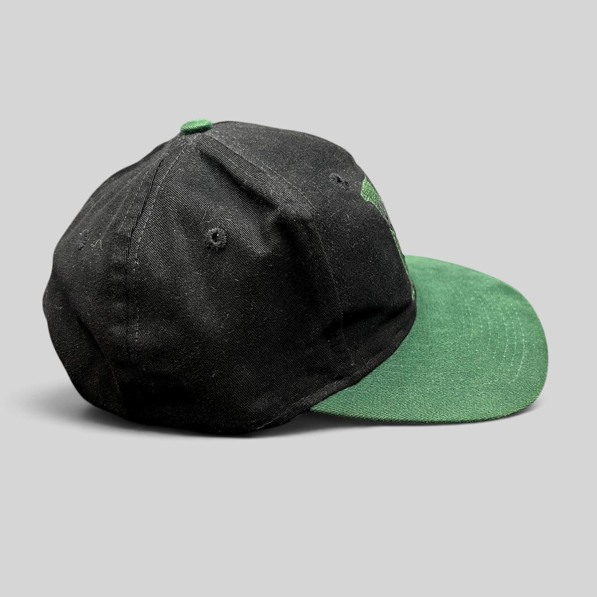 Raree Finds vintage 90s Disney Store Mickey Mouse snapback hat with black crown, green brim, and embroidered M logo.