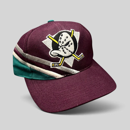 Raree Finds vintage Anaheim Mighty Ducks Apex One snapback hat in maroon with teal, silver, and white wave detail.