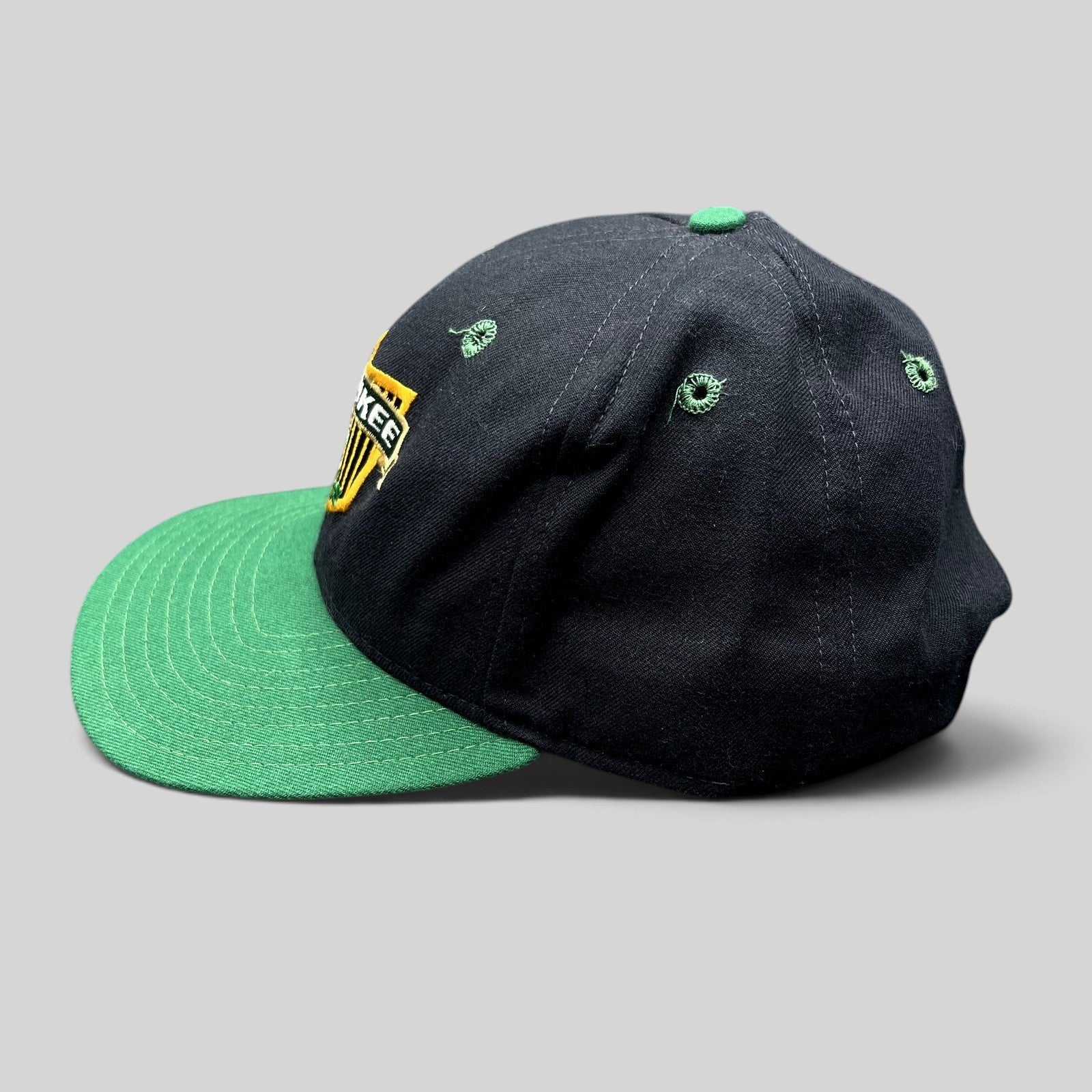 Raree Finds vintage Milwaukee Bucks New Era snapback hat in black and green with embroidered shield logo