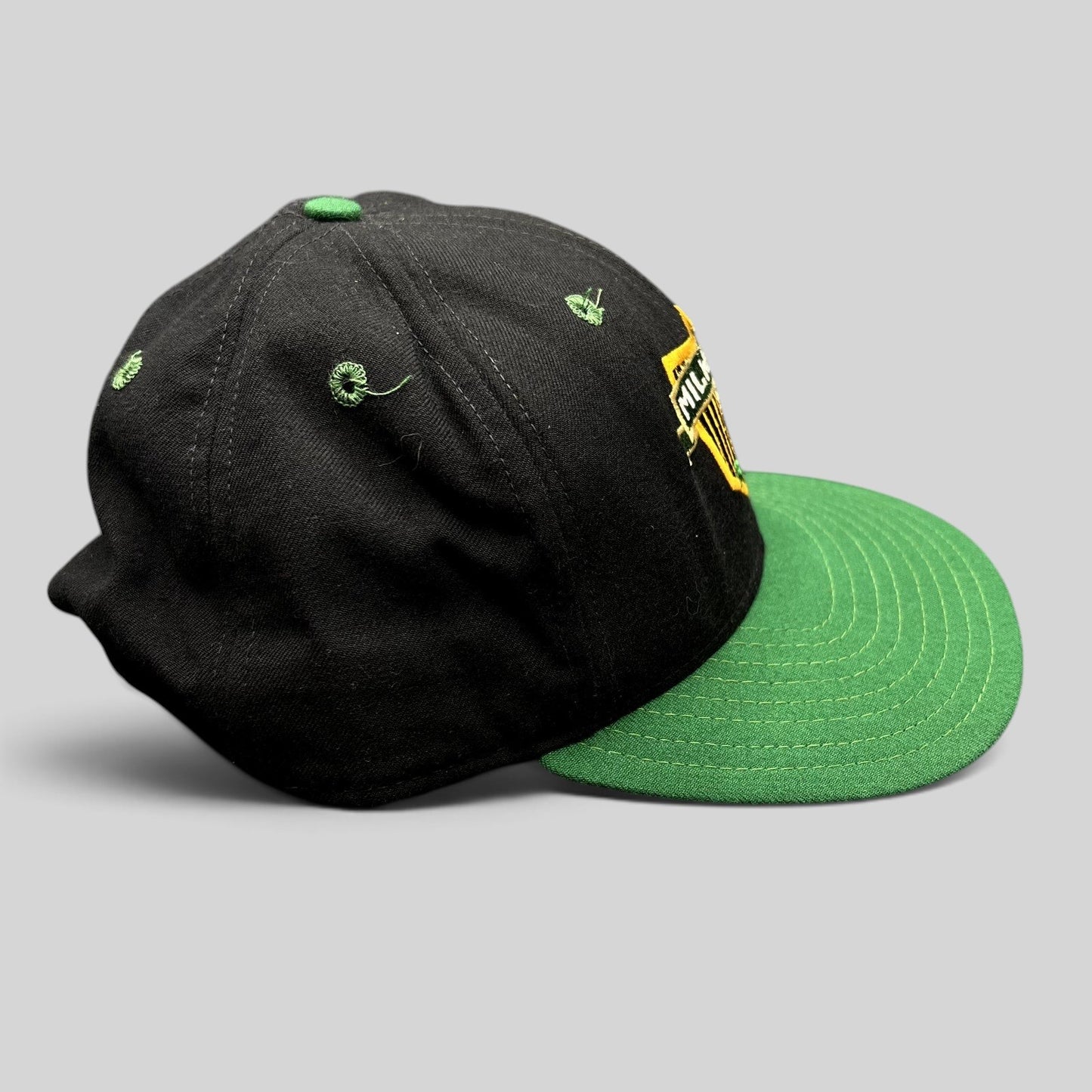 Raree Finds vintage Milwaukee Bucks snapback hat with black crown, green brim, and embroidered team shield logo.