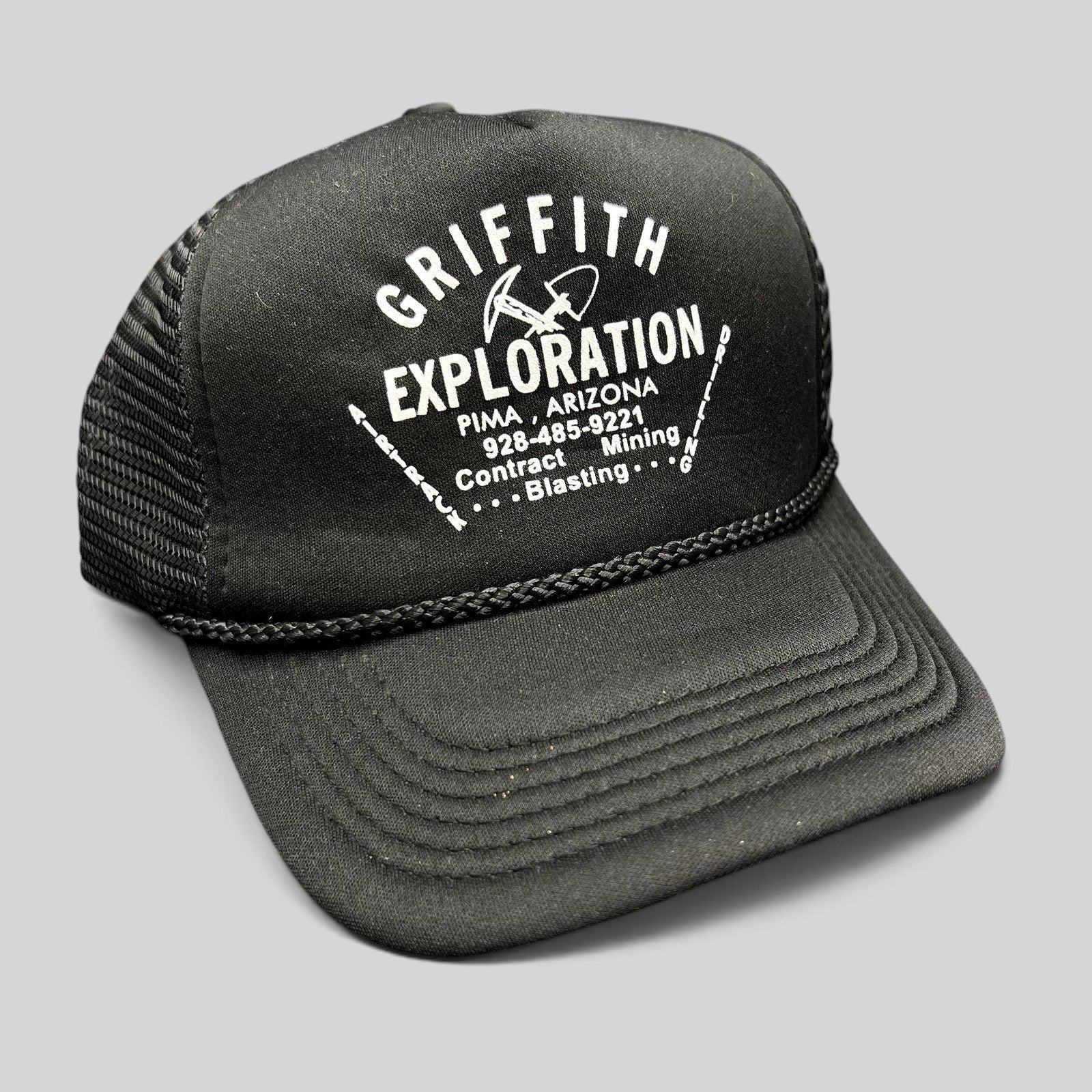 Raree Finds vintage black foam trucker hat with white Griffith Exploration mining company graphic and braided rope