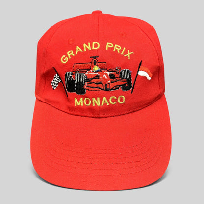 Raree Finds vintage red cotton Monaco Grand Prix racing hat with embroidered Formula 1 car and checkered flag detail.
