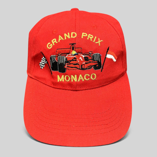 Raree Finds vintage red cotton Monaco Grand Prix racing hat with embroidered Formula 1 car and checkered flag detail.