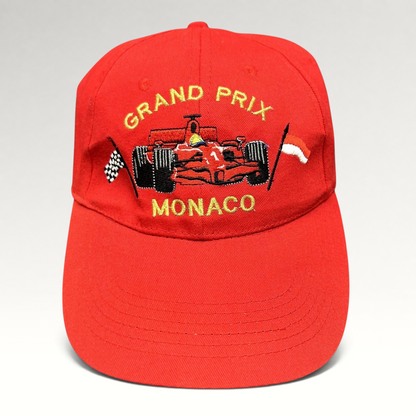 Raree Finds vintage red cotton Monaco Grand Prix racing hat with embroidered Formula 1 car and checkered flag detail.
