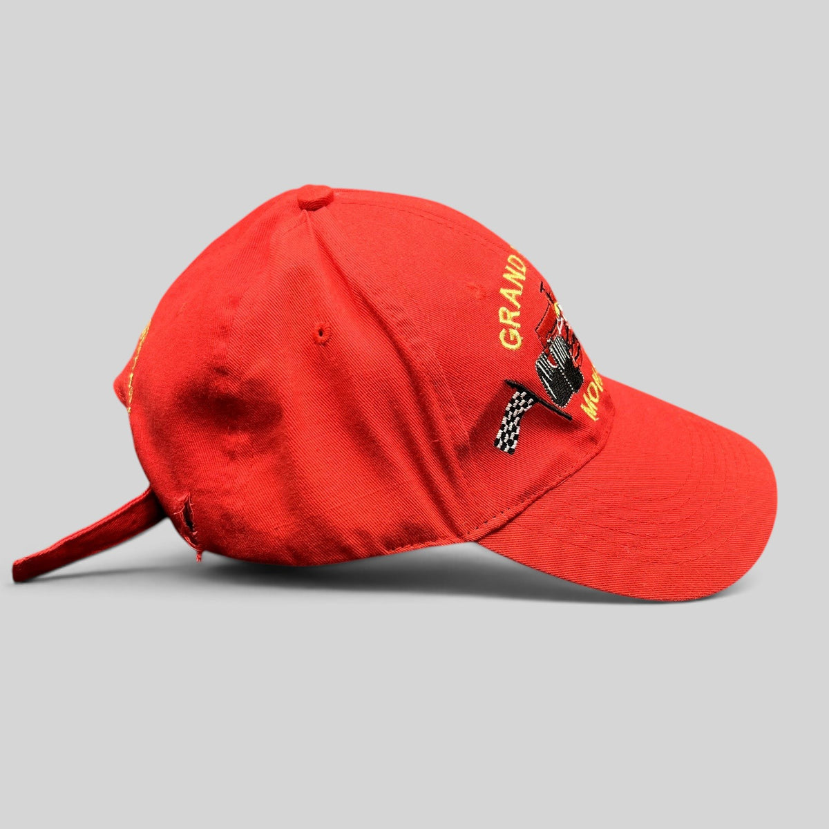 Raree Finds vintage red Monaco Grand Prix strapback hat with embroidered Formula 1 race car and checkered flag detail.