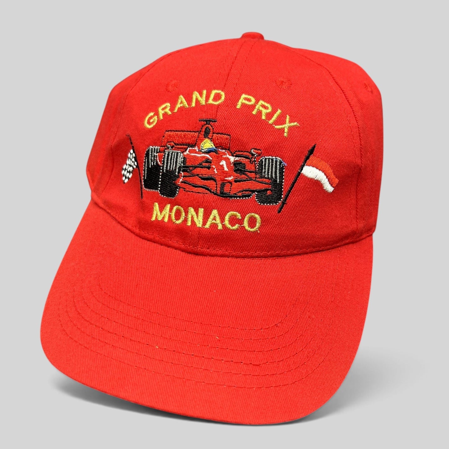 Raree Finds vintage red Monaco Grand Prix strapback hat with embroidered Formula 1 race car and checkered flag detail.