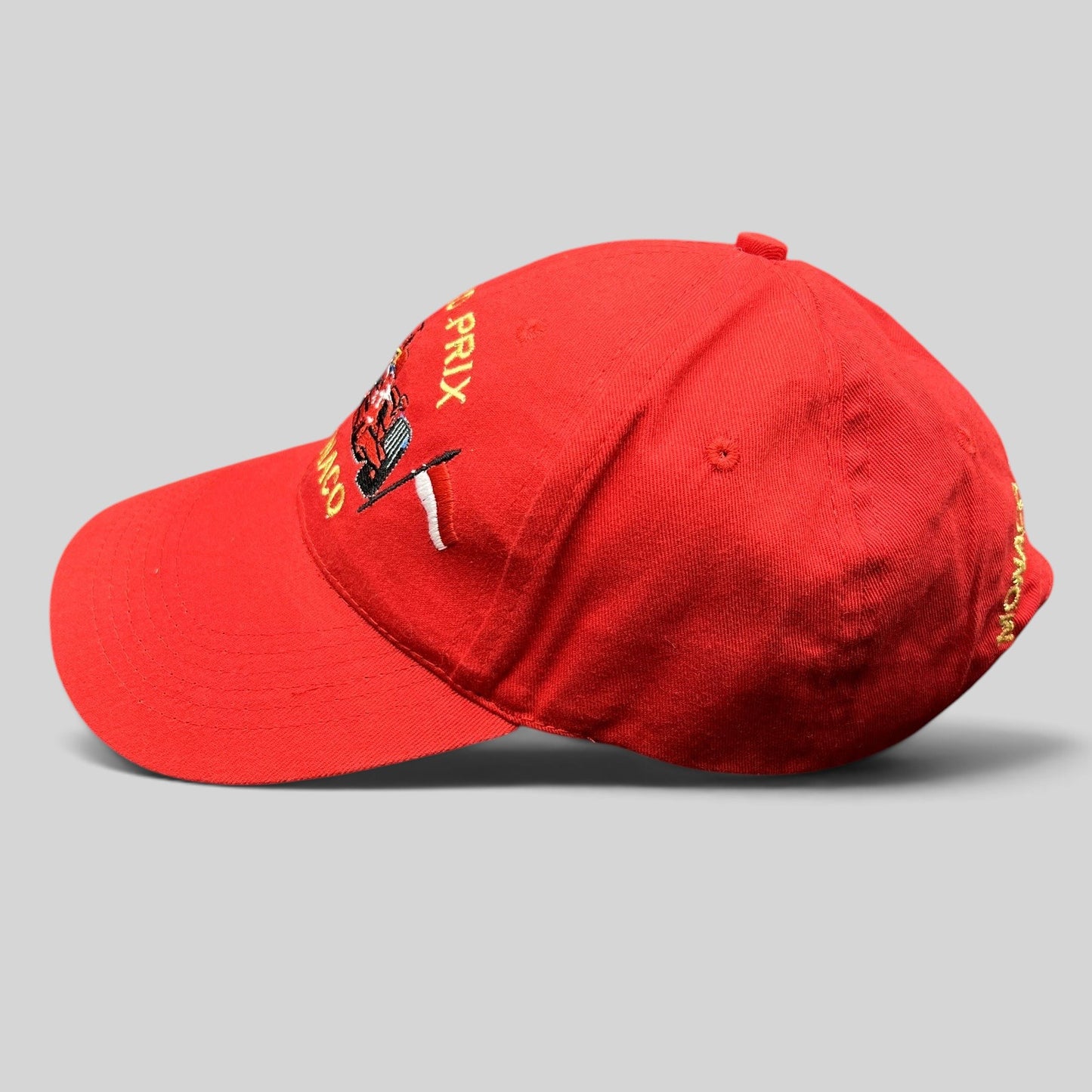 Raree Finds vintage red Monaco Grand Prix strapback hat with embroidered Formula 1 race car and checkered flag detail.