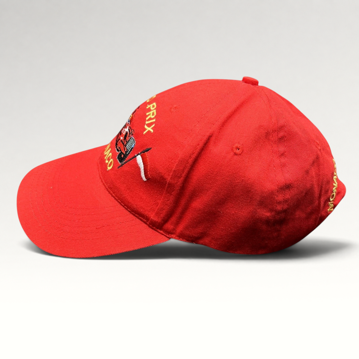 Raree Finds vintage red Monaco Grand Prix strapback hat with embroidered Formula 1 race car and checkered flag detail.