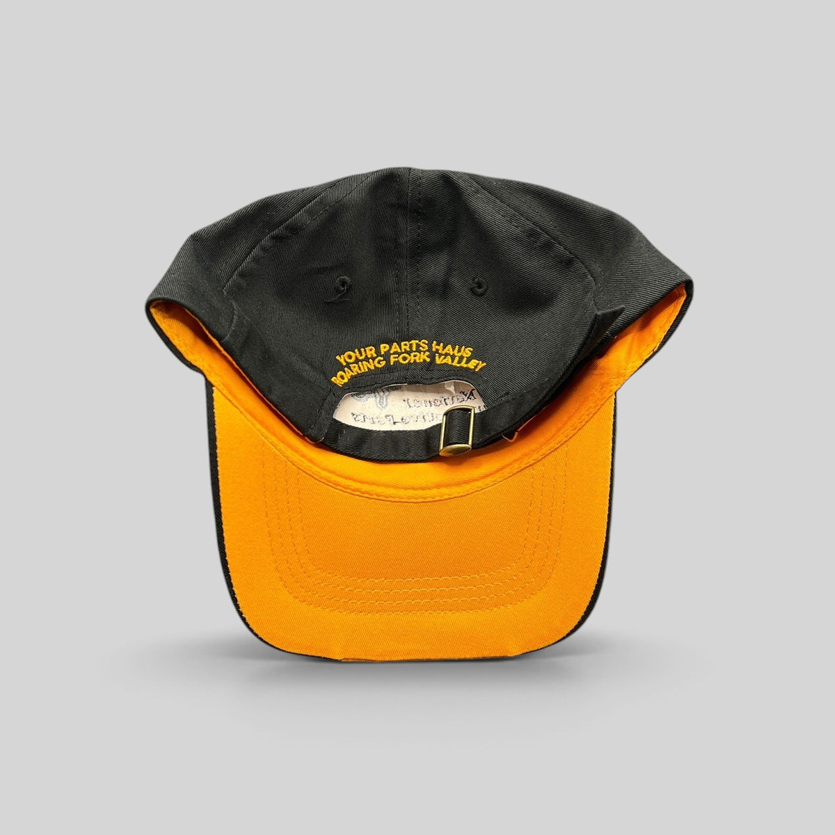 Raree Finds vintage NAPA racing hat in black cotton with a yellow underbrim and adjustable strapback closure.
