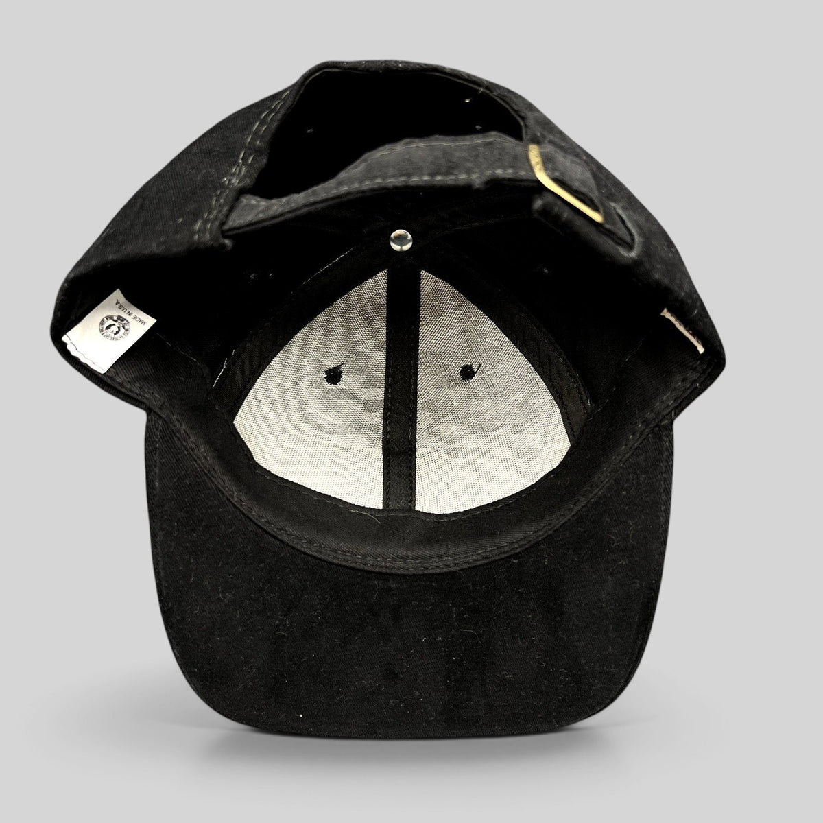 Raree Finds vintage American Needle black cotton strapback hat showing the interior lining and adjustable strap
