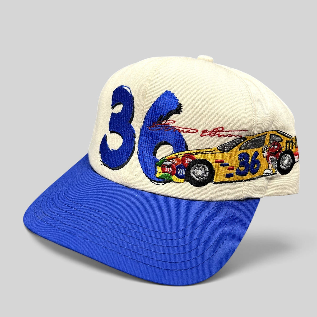 Raree Finds vintage Ken Schrader #36 NASCAR snapback hat with cream crown, royal blue brim, and embroidered race car.