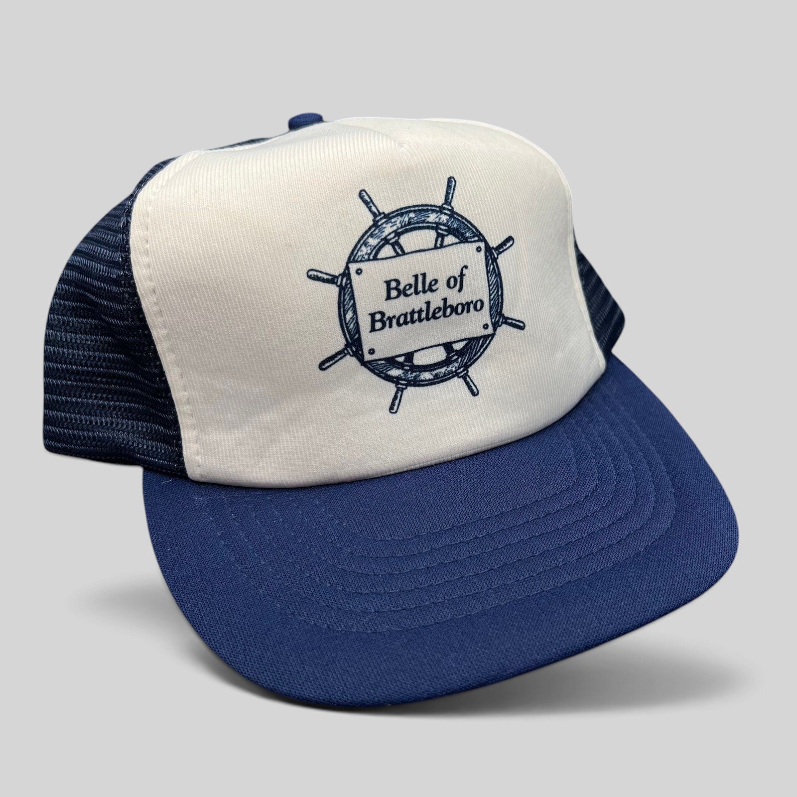 Raree Finds vintage Sunbelt trucker hat with white foam front, navy mesh back, and Belle of Brattleboro ship graphic.