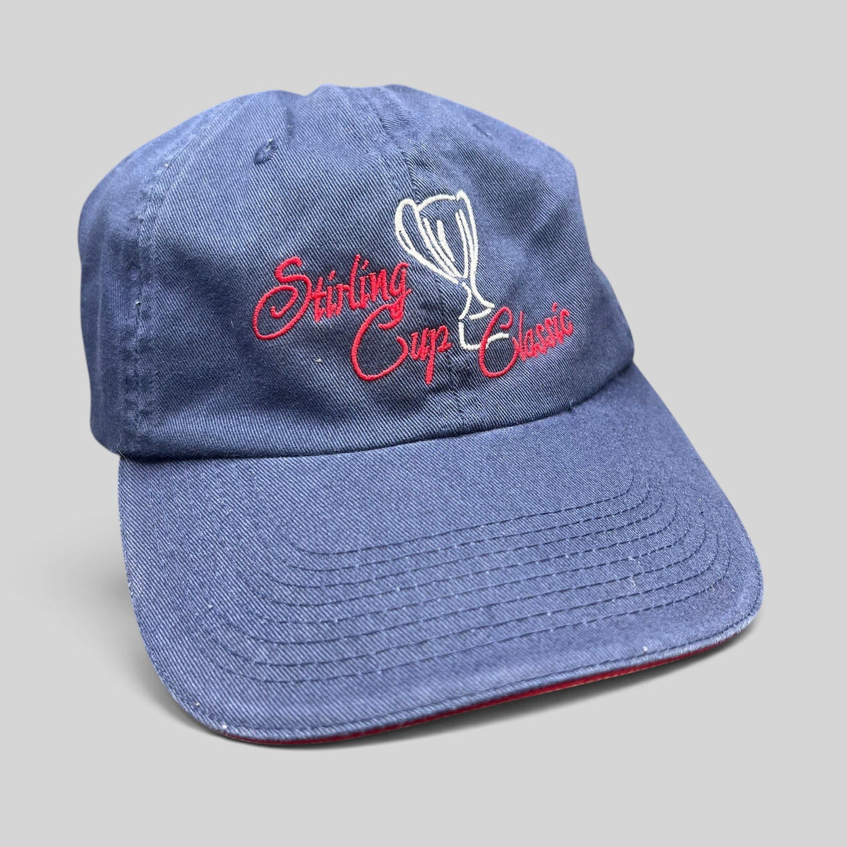 Raree Finds vintage navy blue strapback golf hat with Stirling Cup Classic script embroidery and trophy graphic.