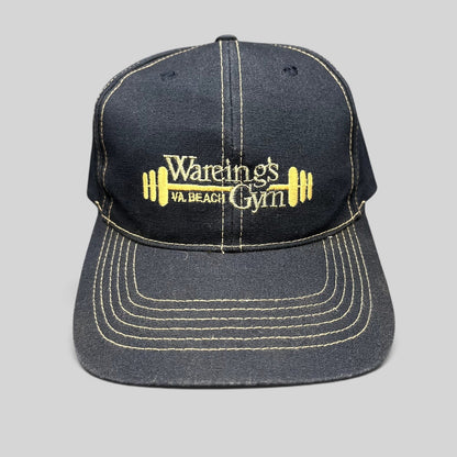 Raree Finds vintage navy blue Wareing’s Gym snapback hat with gold embroidered barbell logo and contrast stitching