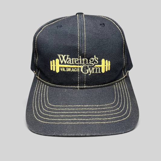 Raree Finds vintage navy blue Wareing’s Gym snapback hat with gold embroidered barbell logo and contrast stitching