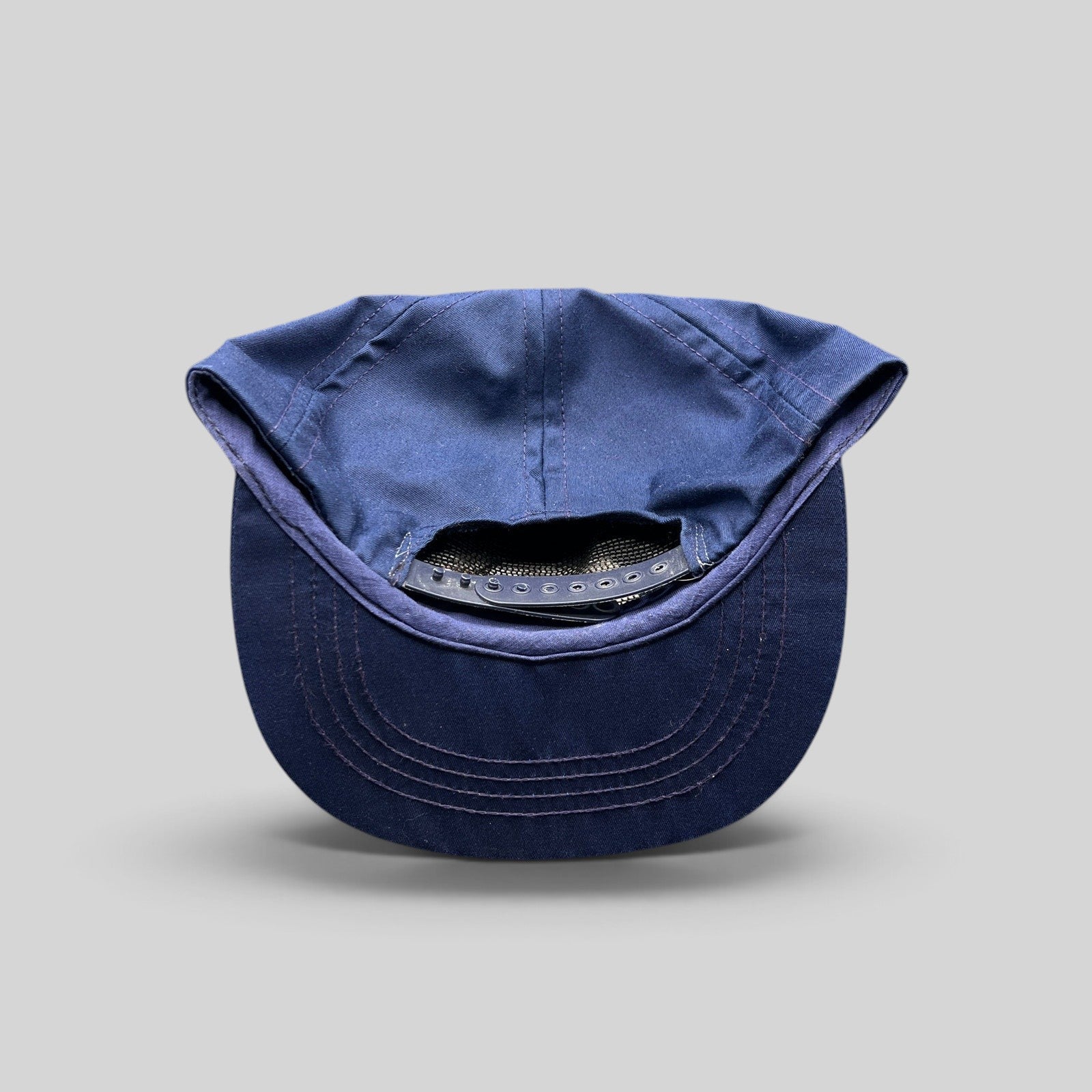 Raree Finds vintage navy blue cotton twill snapback hat showing the adjustable plastic strap closure from the back.