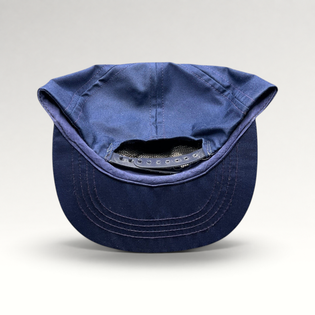 Raree Finds vintage navy blue cotton twill snapback hat showing the adjustable plastic strap closure from the back.