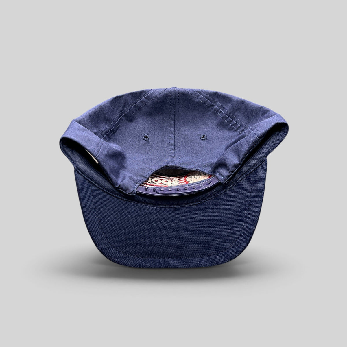 Raree Finds vintage 80s navy blue snapback hat with adjustable plastic closure and structured crown