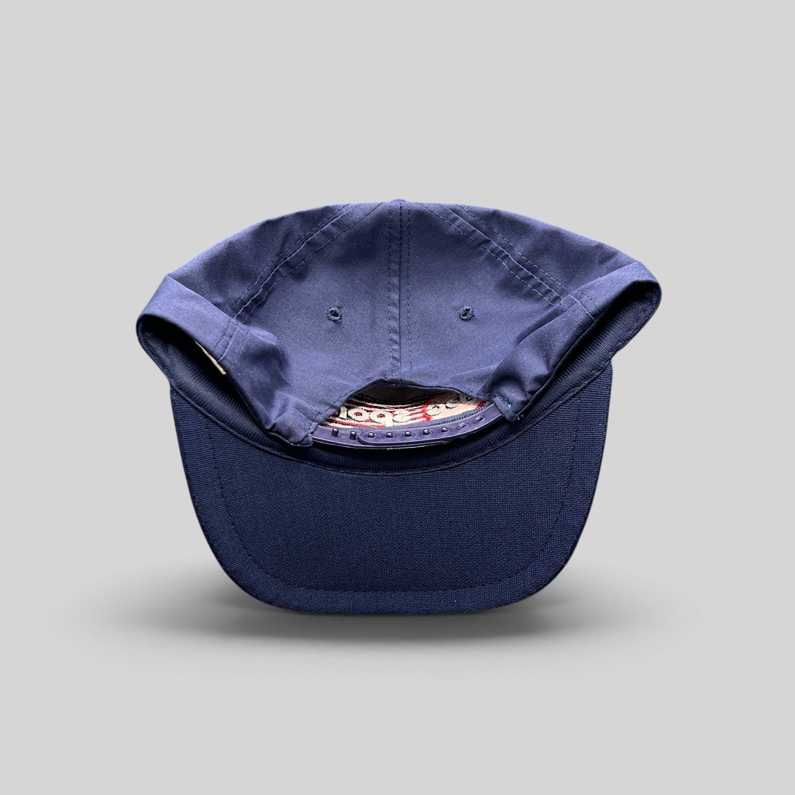Raree Finds vintage 80s navy blue snapback hat with adjustable plastic closure and structured crown