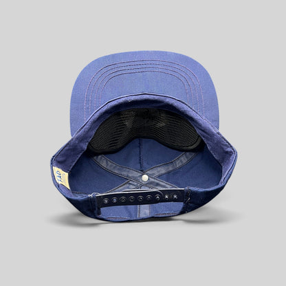 Raree Finds vintage navy blue cotton snapback hat showing the interior construction and FAD Custom Lettering tag