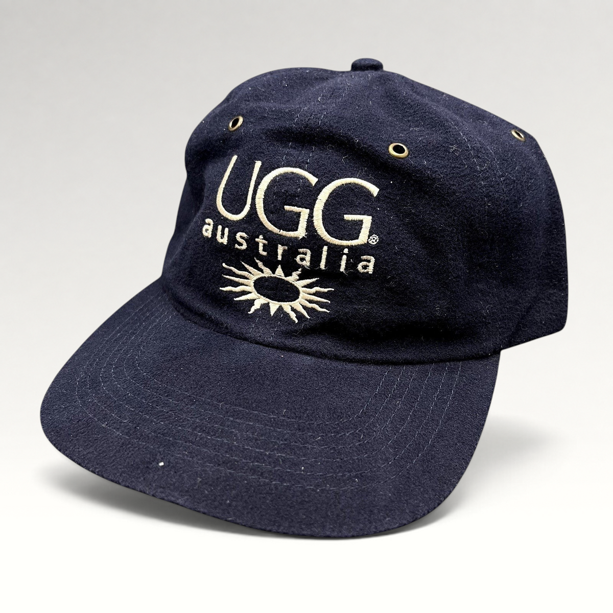 Raree Finds vintage navy blue cotton UGG Australia strapback hat with embroidered logo and sunburst graphic