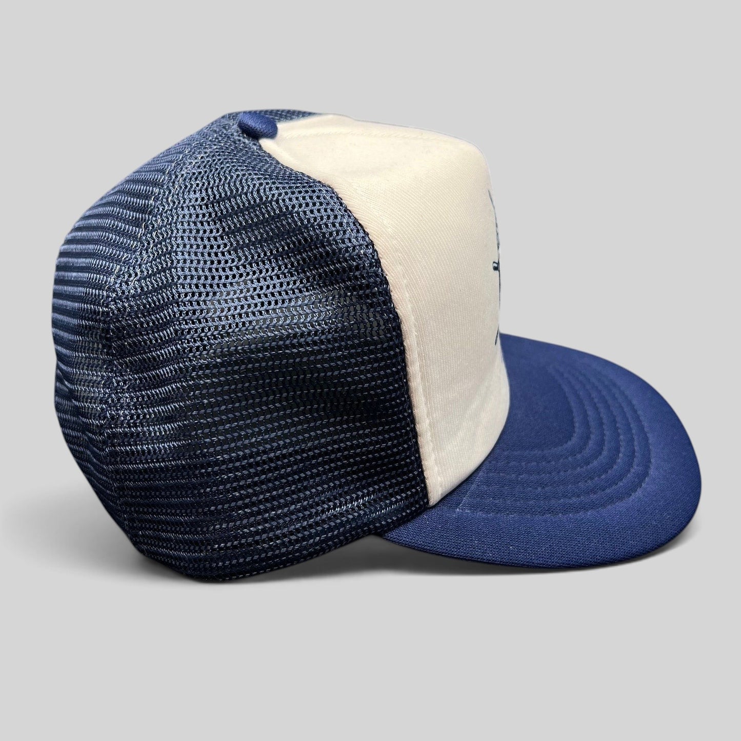 Raree Finds vintage Sunbelt snapback trucker hat with a white foam front, navy mesh back, and navy brim.